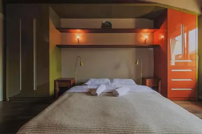 a bed with two pillows on it in a room at SAW! KRAKÓW Apartments - Studencka in Kraków