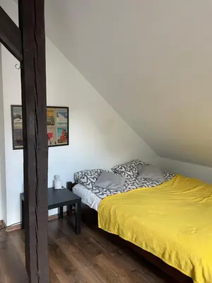 a bedroom with a bed with a yellow bedspread at Piekny,duzy loft 80 metrow blisko centrum in Kraków