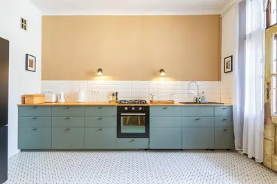 a kitchen with blue cabinets and a sink at Vintage Charm-3 Bedrooms-Old Town in Kraków