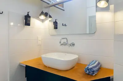 a bathroom with a white sink and a mirror at Vintage Charm-3 Bedrooms-Old Town in Kraków