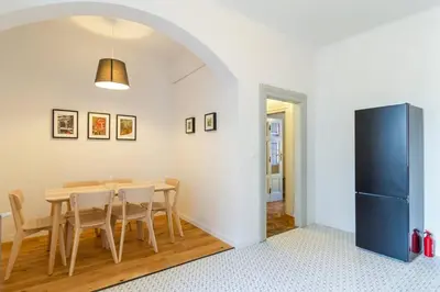 a dining room with a table and a refrigerator at Vintage Charm-3 Bedrooms-Old Town in Kraków