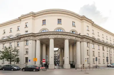 a large building with cars parked in front of it at Vintage Charm-3 Bedrooms-Old Town in Kraków
