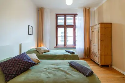 a bedroom with two beds and a window and a dresser at Vintage Charm-3 Bedrooms-Old Town in Kraków