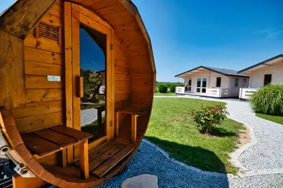 a wooden outhouse with a bench in a yard at Wiklinowa Oaza Zator by Housine in Zator
