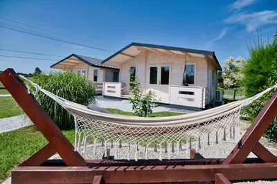 a hammock in front of a tiny house at Wiklinowa Oaza Zator by Housine in Zator