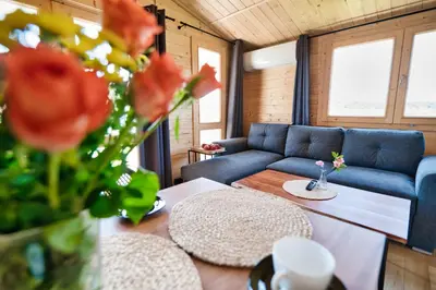 a living room with a couch and a table at Wiklinowa Oaza Zator by Housine in Zator