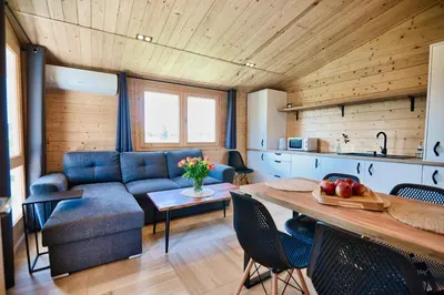 a living room with a blue couch and a table at Wiklinowa Oaza Zator by Housine in Zator