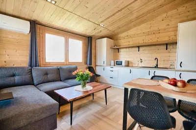 a living room with a couch and a table at Wiklinowa Oaza Zator by Housine in Zator