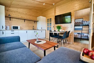 a living room with a couch and a table at Wiklinowa Oaza Zator by Housine in Zator