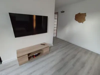 a living room with a flat screen tv on a wall at U Tofika in Grzechynia