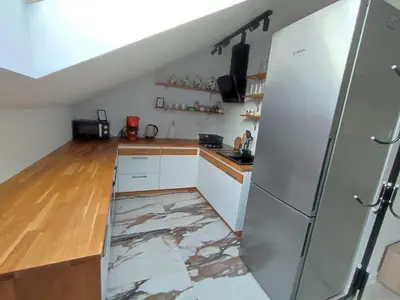 a kitchen with a marble floor and a refrigerator at U Tofika in Grzechynia