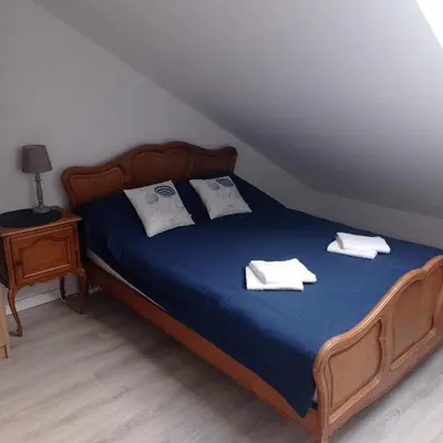 a bedroom with a bed with two towels on it at U Tofika in Grzechynia