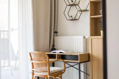 a bedroom with a desk and a large window at Modern Apartment CityBeat#10 in Kraków