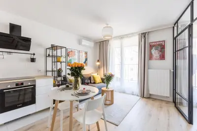 a small kitchen with a table with plates and dishes at Modern Apartment CityBeat#10 in Kraków