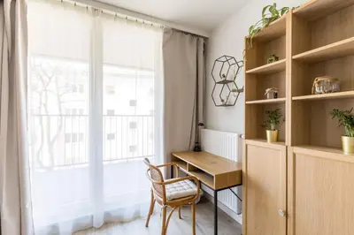 a white dresser with a window in a room at Modern Apartment CityBeat#10 in Kraków
