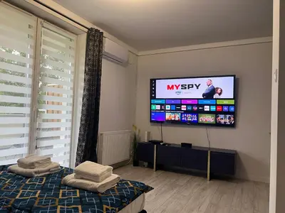a living room with a tv on the wall at Apartament Bastian Złocień Kraków in Kraków