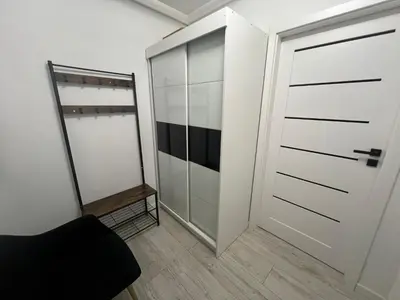 a closet with a glass door and a mirror at Apartament Bastian Złocień Kraków in Kraków