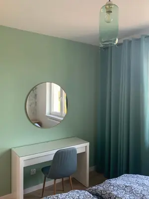 a bedroom with a mirror and a bed and a chair at Smile 2 in Tomice
