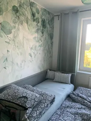 a bedroom with two beds and a wall at Smile 2 in Tomice