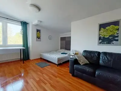 a living room with a couch and a bed at pokoje przytulnie jak w domu in Kraków