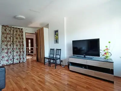 a living room with a flat screen tv on a entertainment center at pokoje przytulnie jak w domu in Kraków