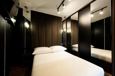 a bedroom with two beds and a mirror at Native Apartments Kościuszki 39I11 in Kraków