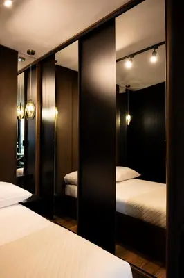 a bedroom with two beds and a mirror at Native Apartments Kościuszki 39I11 in Kraków