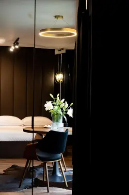 a room with a table and a bed and a table and chairs at Native Apartments Kościuszki 39I11 in Kraków