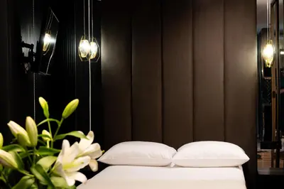 a bedroom with a bed with two pillows and a plant at Native Apartments Kościuszki 39I11 in Kraków