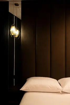 a black bedroom with a bed and a lamp at Native Apartments Kościuszki 39I11 in Kraków