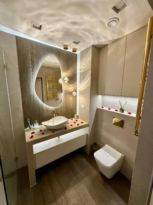 a bathroom with a sink and a toilet and a mirror at Masarska 8 VIP Apartamenty JACUZZI in Kraków