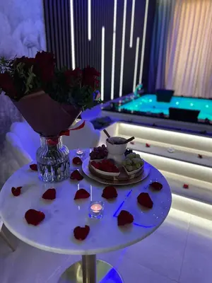 a table with hearts and a vase of flowers at Masarska 8 VIP Apartamenty JACUZZI in Kraków