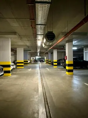an empty parking garage with cars parked in it at Masarska 8 VIP Apartamenty JACUZZI in Kraków