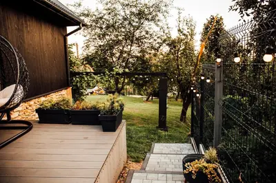 a garden with potted plants on a wooden walkway at Stodoła Na Kamionce in Kwaczała