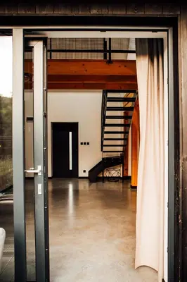 an open room with a staircase in a building at Stodoła Na Kamionce in Kwaczała