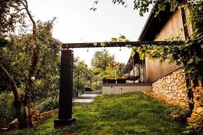 a garden with a brick building and a stone wall at Stodoła Na Kamionce in Kwaczała