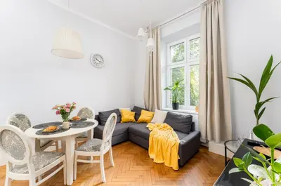 a living room with a couch and a table at Tomasza Apartments by VSI in Kraków