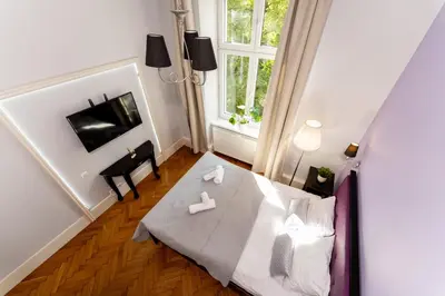 a small room with a table and a window at Tomasza Apartments by VSI in Kraków
