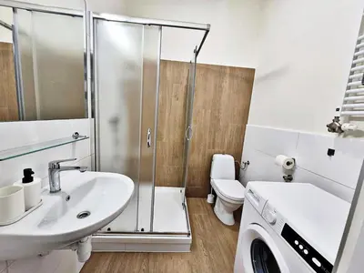 a bathroom with a shower and a sink and a toilet at DReAM Main Station in Kraków