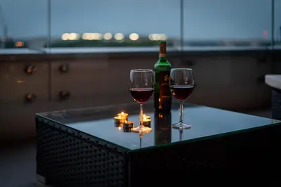 two glasses of wine and a bottle on a table at Wiślane Tarasy - UNIQUE Apartments 4YOU - 9 piętro z pięknym widokiem na centrum Krakowa in Kraków
