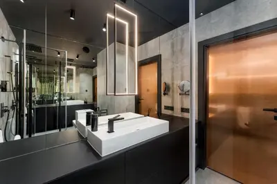 a bathroom with a white sink and a shower at Wiślane Tarasy - UNIQUE Apartments 4YOU - 9 piętro z pięknym widokiem na centrum Krakowa in Kraków