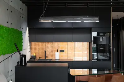 a kitchen with black cabinets and a glass table at Wiślane Tarasy - UNIQUE Apartments 4YOU - 9 piętro z pięknym widokiem na centrum Krakowa in Kraków