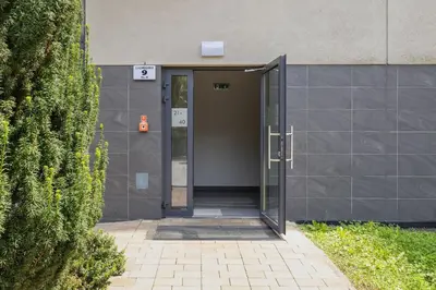 an entrance to a building with an open door at Apartament w Spokojnej Okolicy z Parkingiem by Noclegi Renters in Kraków
