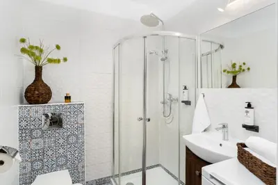 a bathroom with a shower and a sink at LORETO 1 by Cozyplace in Kraków