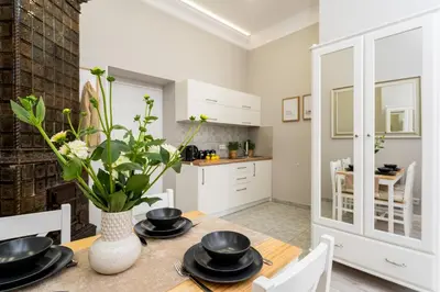 a kitchen and dining room with a table and chairs at LORETO 1 by Cozyplace in Kraków