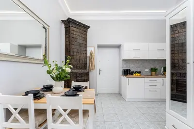 a kitchen and dining room with a table and chairs at LORETO 1 by Cozyplace in Kraków