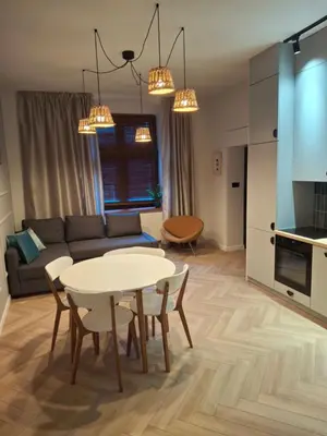 a living room with a table and a couch at Komfortowy apartament in Bochnia