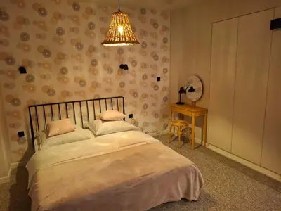 a bedroom with a bed and a lamp and a table at Komfortowy apartament in Bochnia