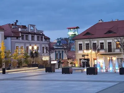 a city square with buildings and a clock tower at Komfortowy apartament in Bochnia