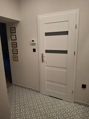 a door in a room with a tile floor at Komfortowy apartament in Bochnia